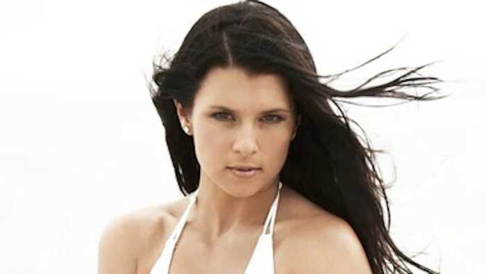 Danica Patrick poses in a white bikini.